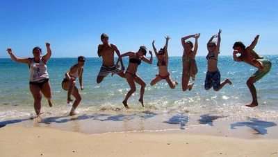 Group photo at the beach Explore the coral coast with Sightseeing Pass Australia.
